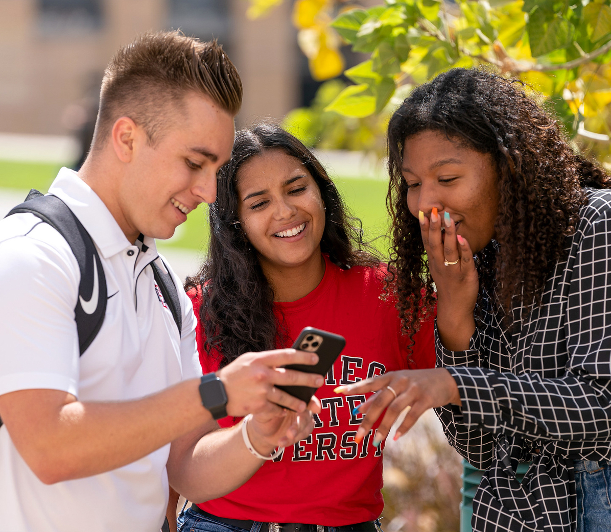 Three students laughing