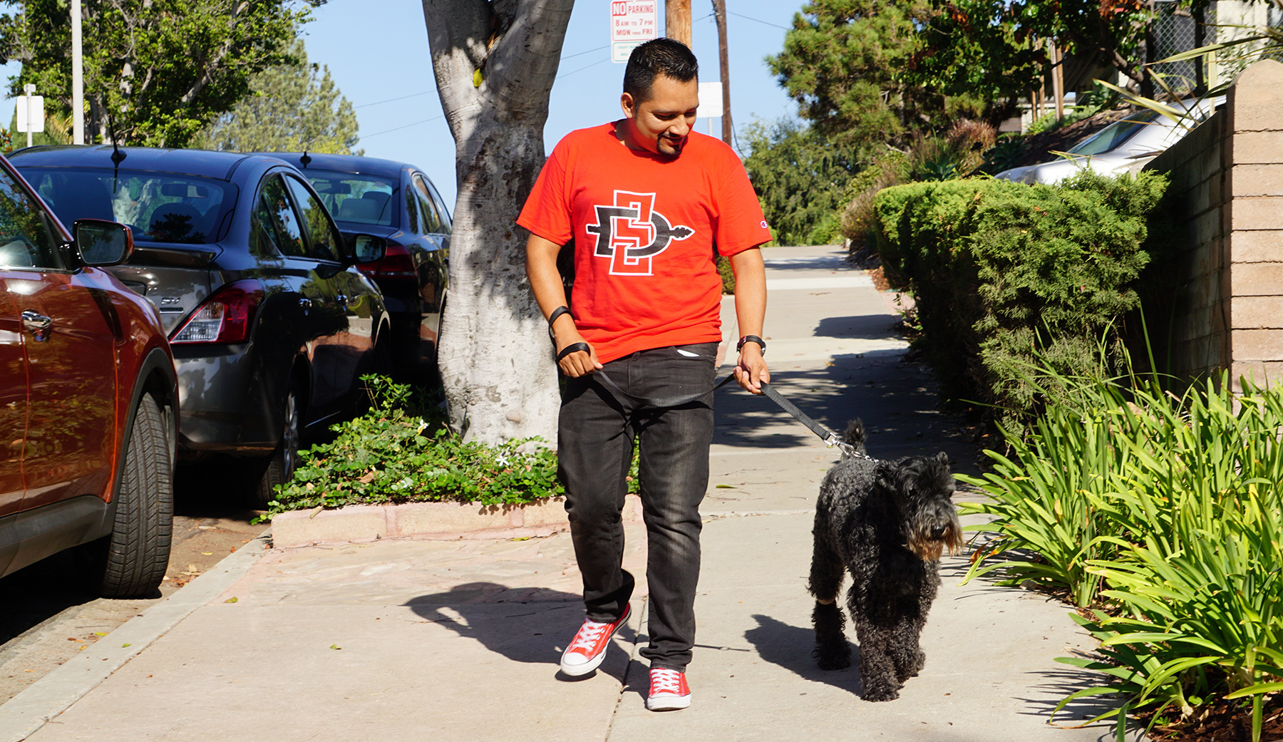 Student walking a dog.