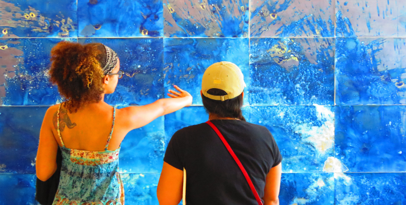 2 people looking at a painting splatter