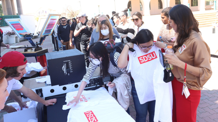 People receiving SDSU branded shirts