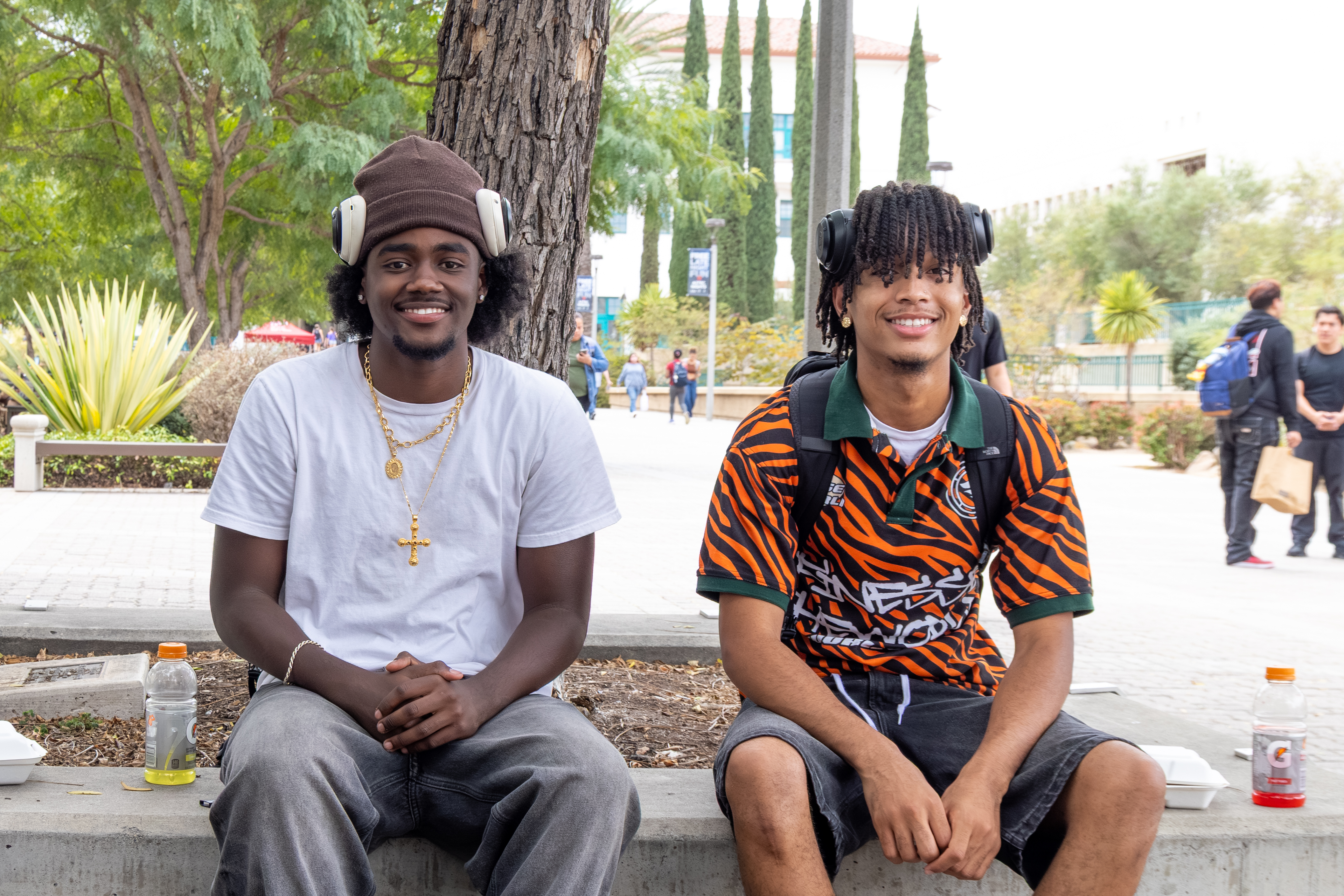 2 students sitting on benches smiling
